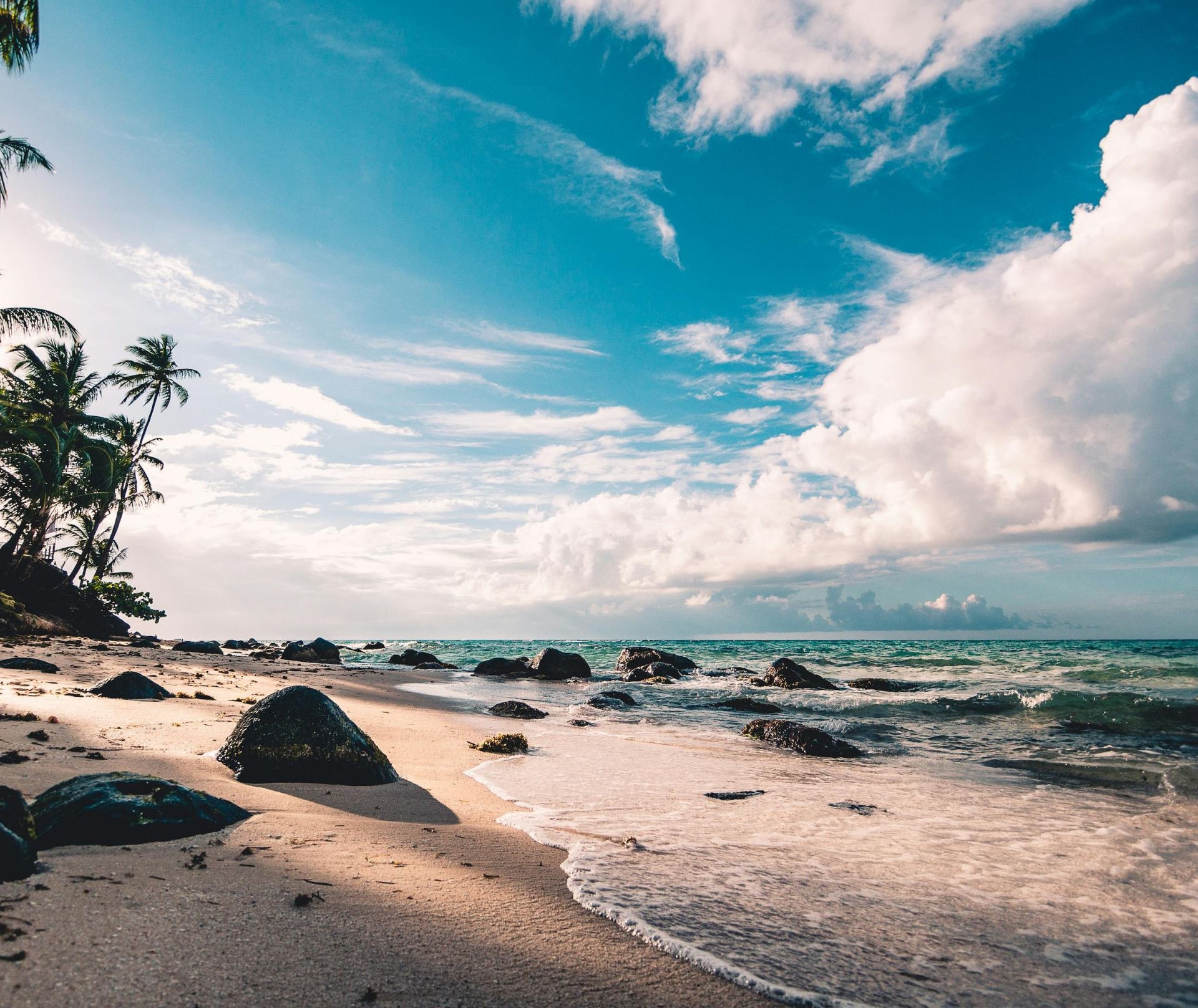 A receptionist and client converse over an appointment book at a clinic reception desk.
